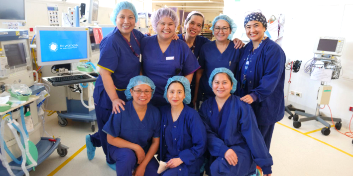 Smiling group photo of Filipino nurses in the operating theatre at the Women's