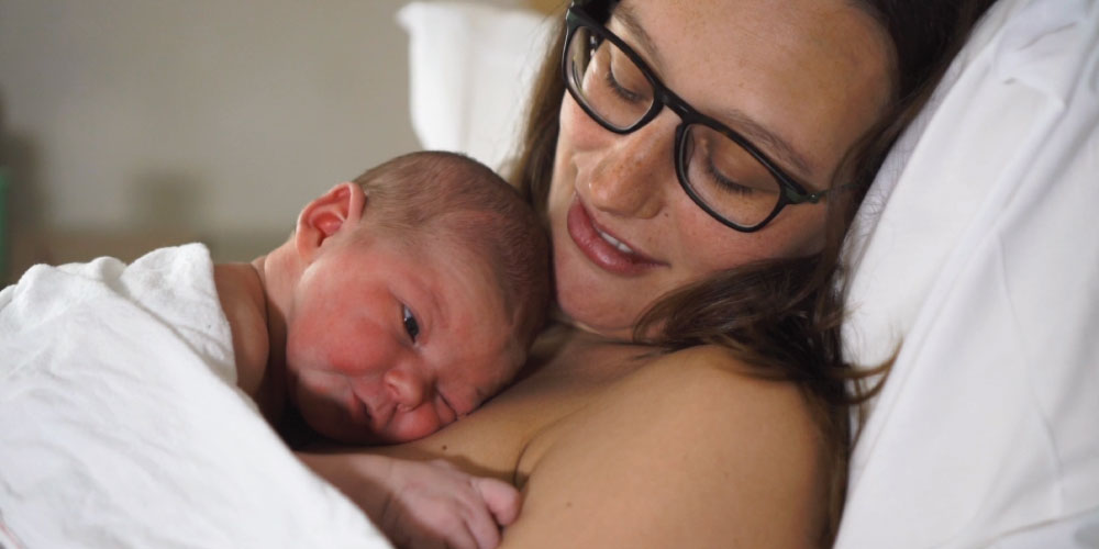 newborn baby has skin-to-skin contact with mother