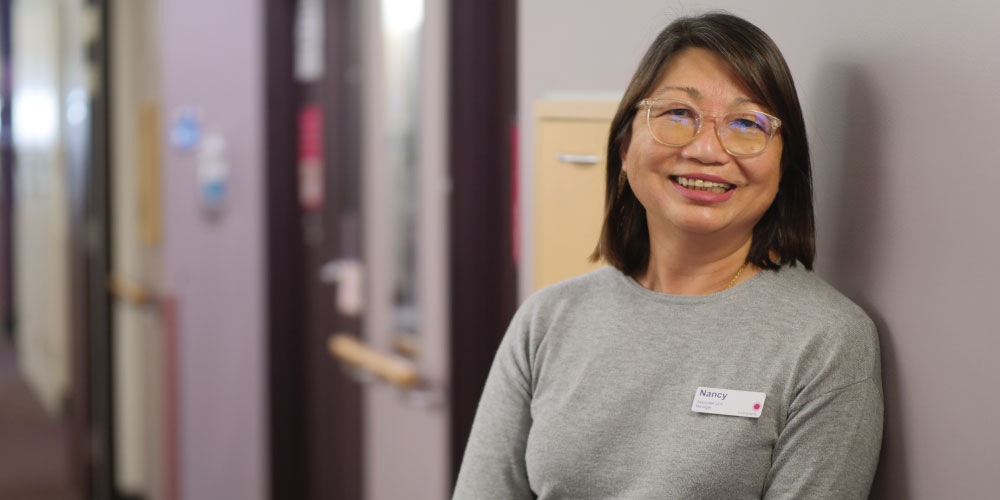 Midwife Nancy Leong, pictured smiling in a ward at the Women's, says midwifery is her dream job.