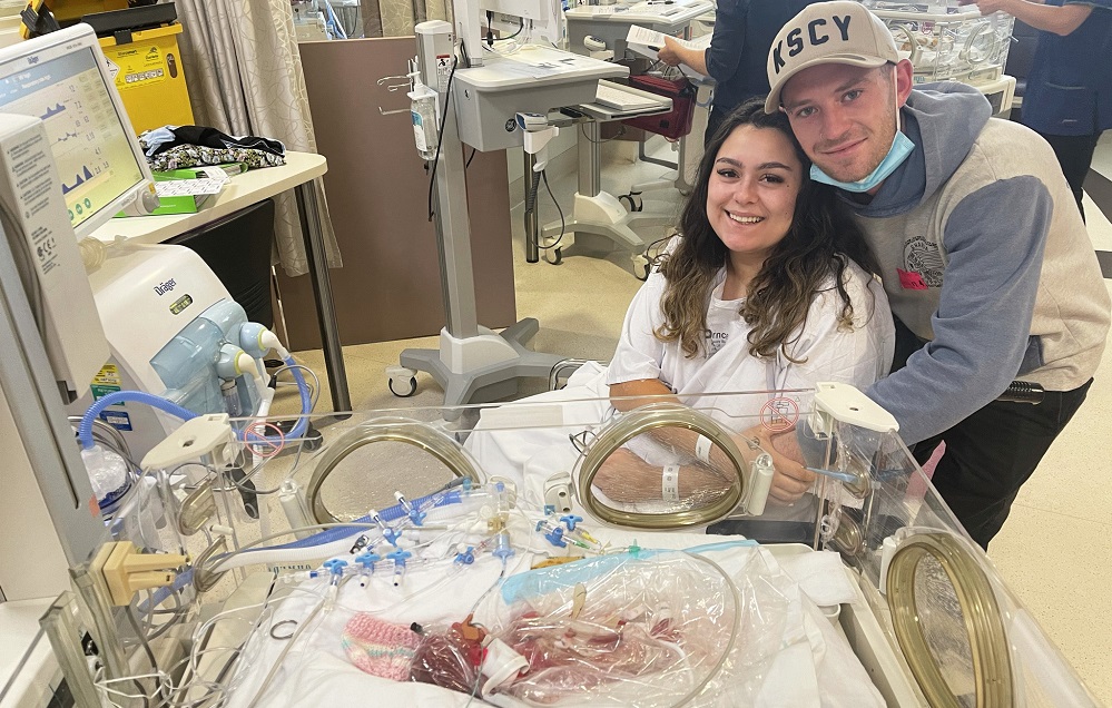 Sky and Trisdan with baby Remi in the Women’s NICU before the twins passed away.