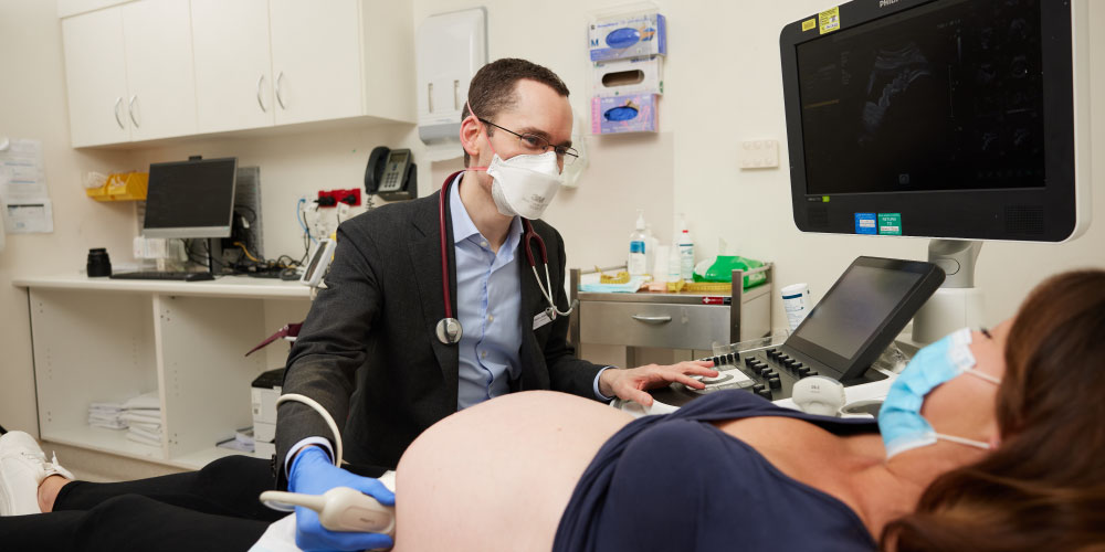 Dr Stefan Kane performs ultrasound on a pregnant woman.