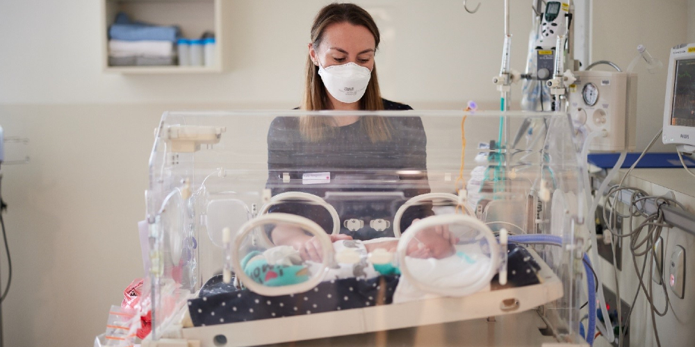 Dr Kate Hodgson, a researcher and clinician at the Women’s, with baby Louis in our Newborn Intensive Care Unit.