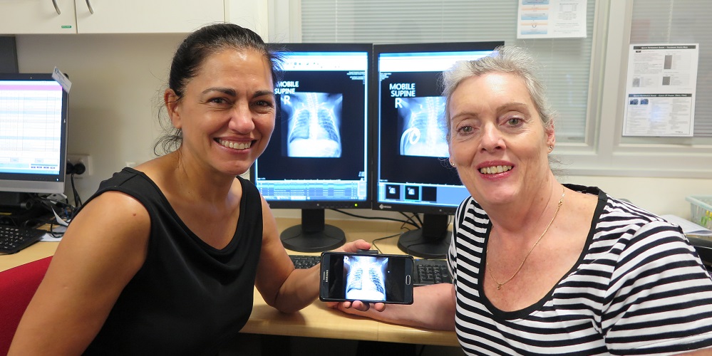 The Women's Dr Marta Thio and Dr Jennifer Dawson look at an x-ray of a baby's lung 