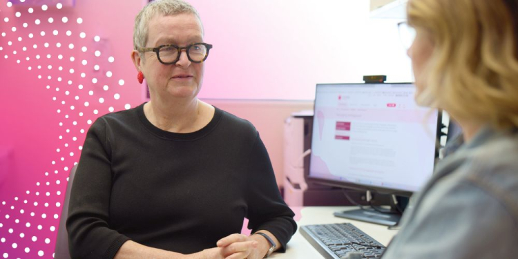 Prof Martha Hickey, wearing glasses, speaks with a patient at the Women’s Menopausal Symptoms after Cancer (MSAC) Clinic.